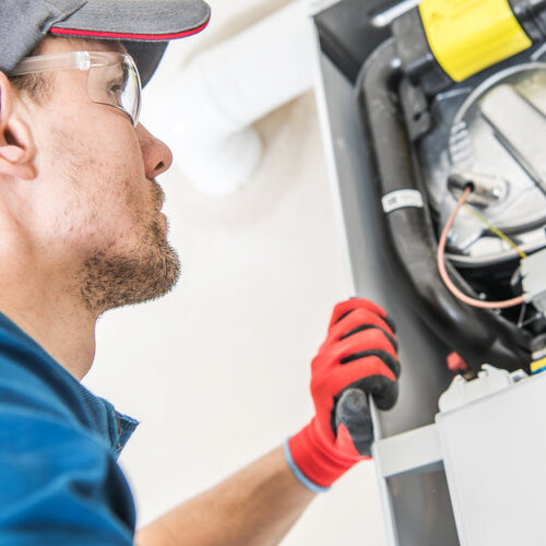 Technician checking furnace for problems