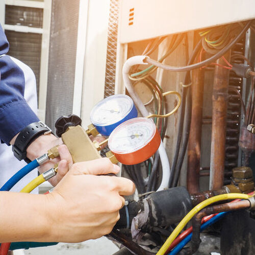 technician is checking air conditioner