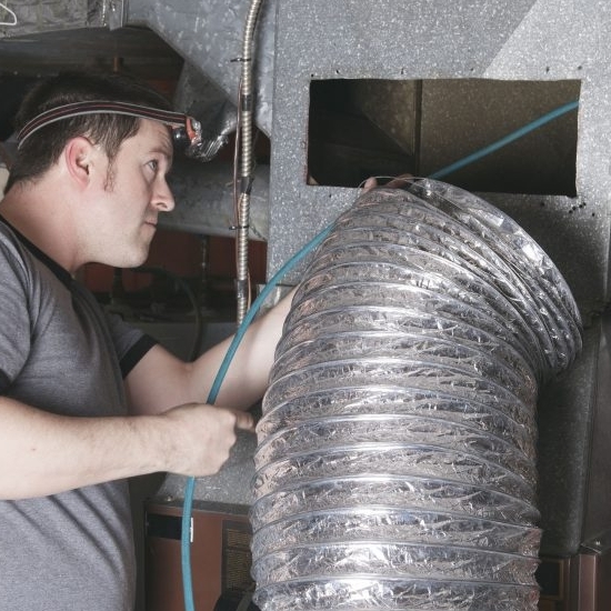 technician cleaning ventilation system