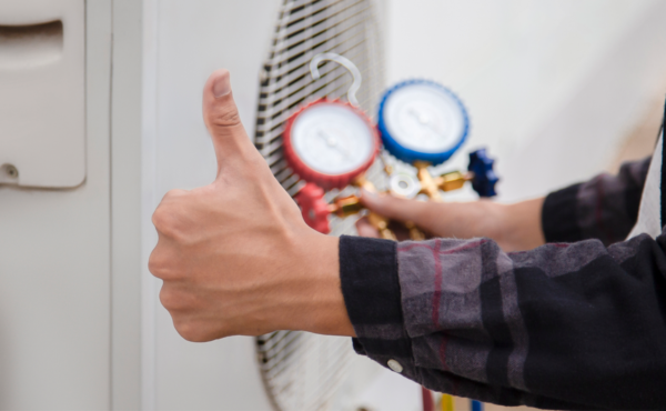 Technician is checking air conditioner, measuring equipment for filling air conditioners.